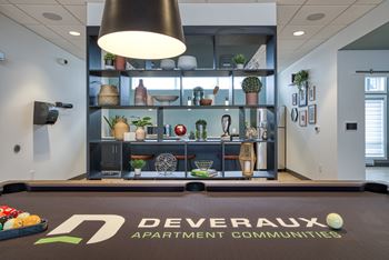 A room with a sign that says "DEVERAUX APARTMENT COMMUNITIES" on the floor.